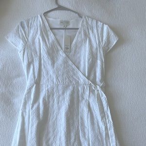 Francesca’s brand new white wrap dress